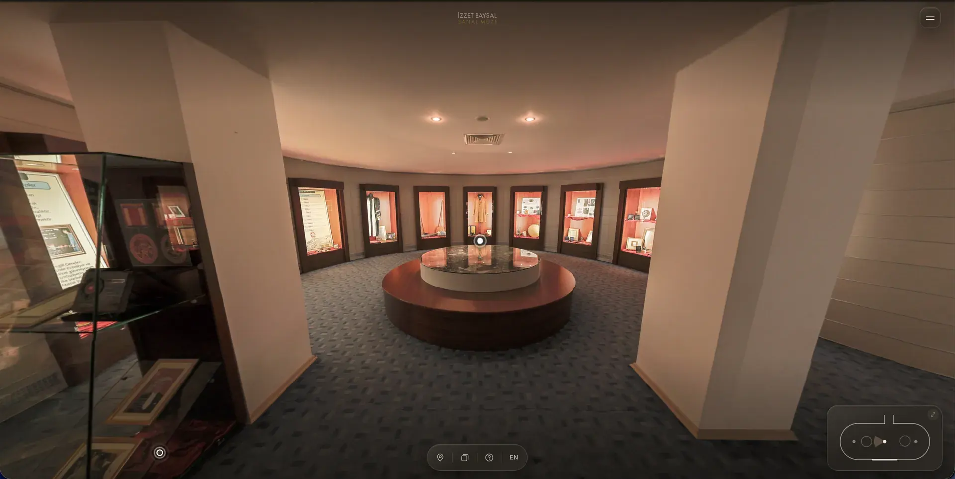 Dijital müzenin 360 derece sergi salonu görünümü: vitrinler ve ortadaki yuvarlak masa